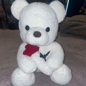 stuffed bear holding rose